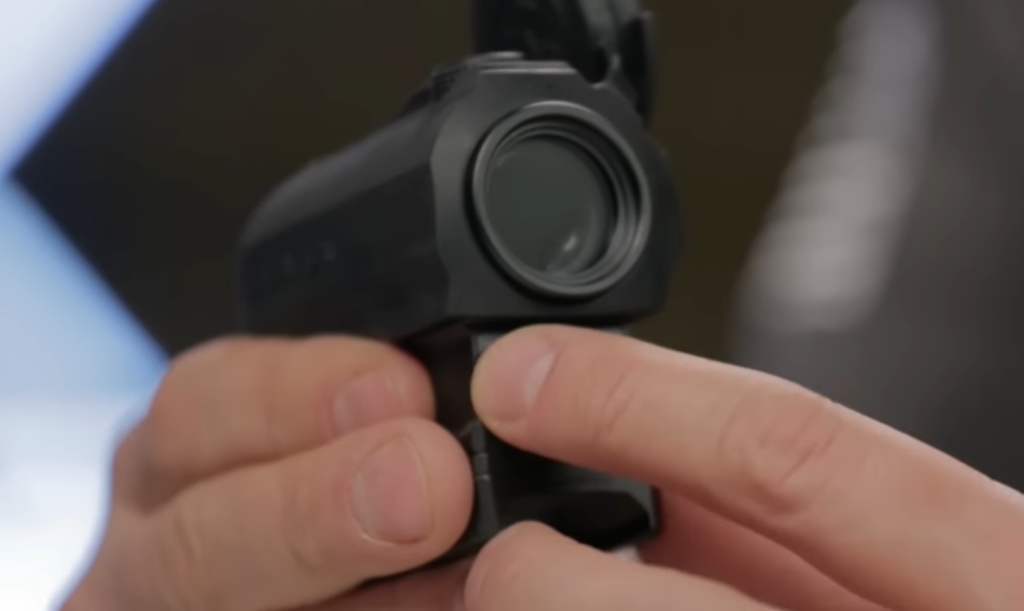person holds Vortex Sparc ar in one hand, with another points at it with a finger