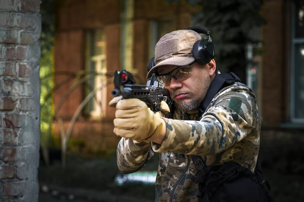 A man looks through the scope of a shotgun