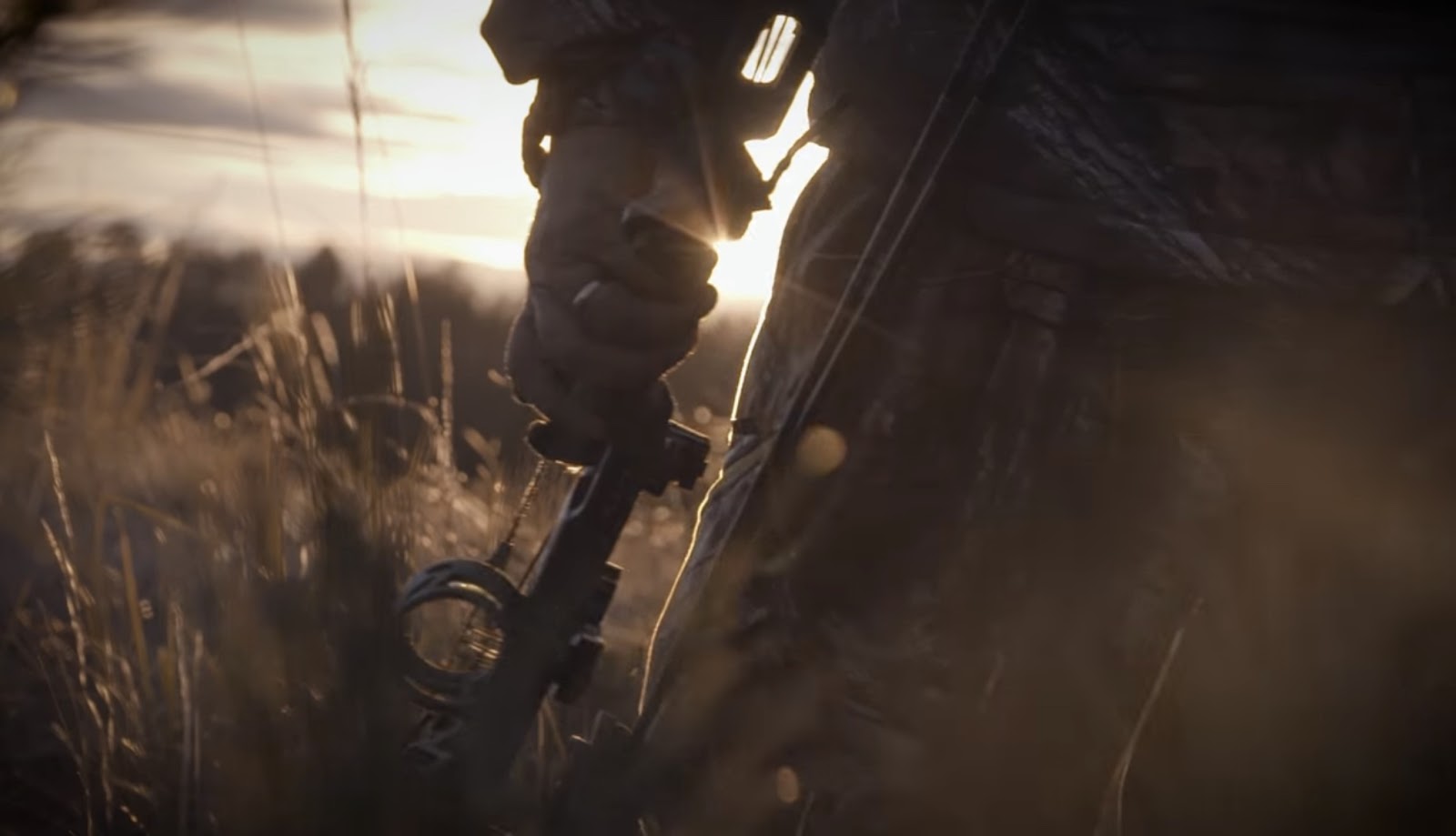 Man with hunting attribute in the field.