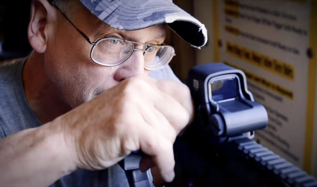 man shoots a weapon