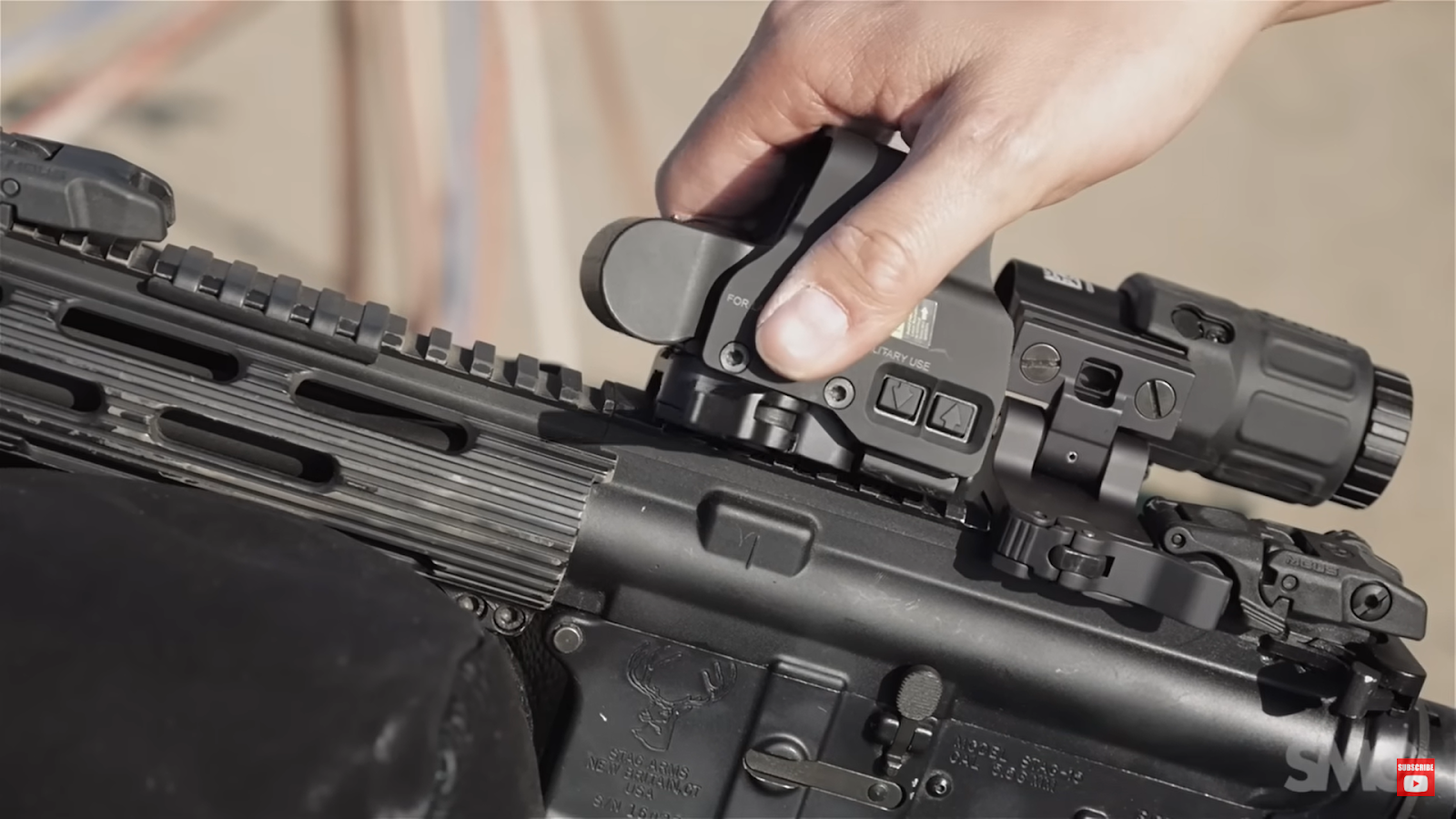hand holds the weapon with EOTech XPS2 on it
