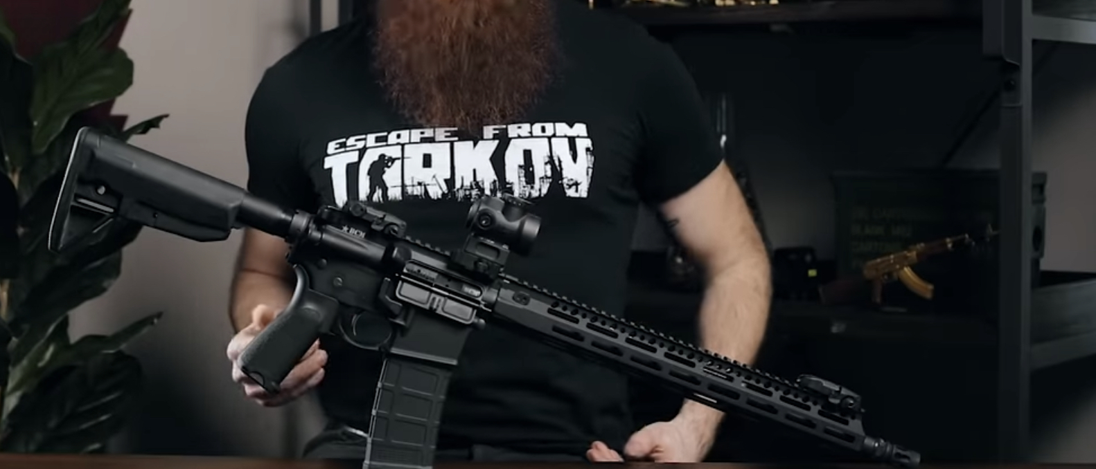 Man is reviewing Trijicon MRO.