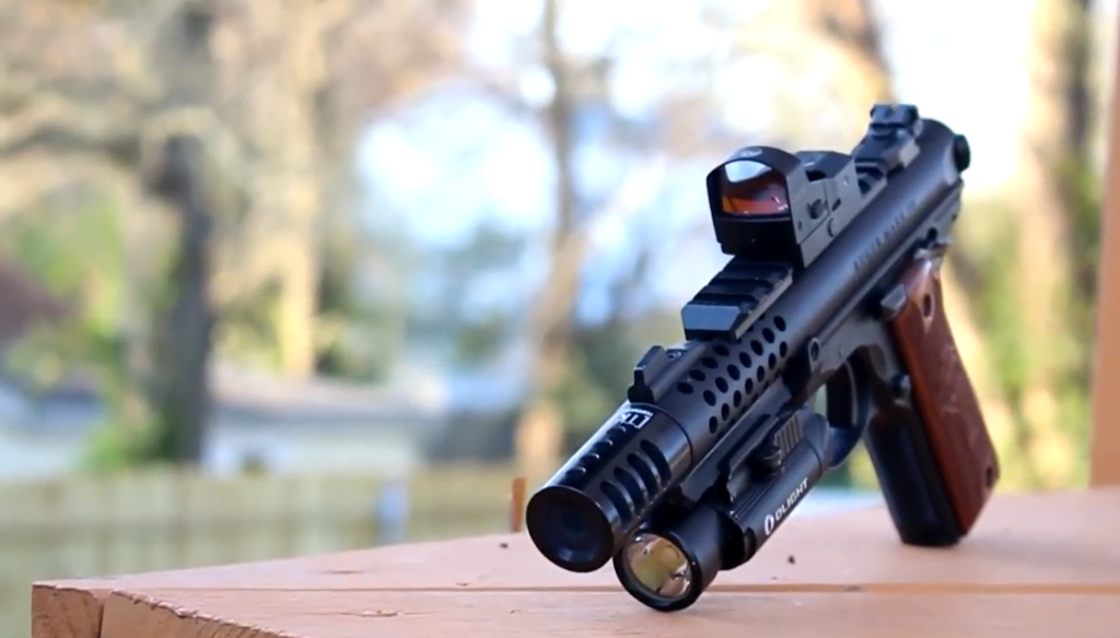 a gun with Burris Fastfire 3 on it on a wooden table outside